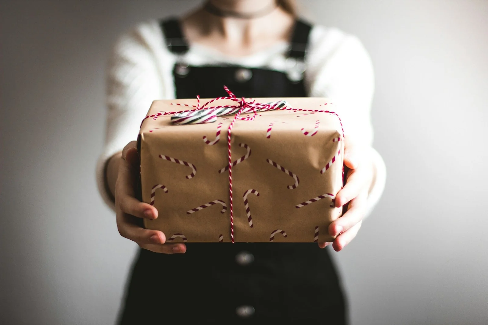 A wrapped gift held out with both hands